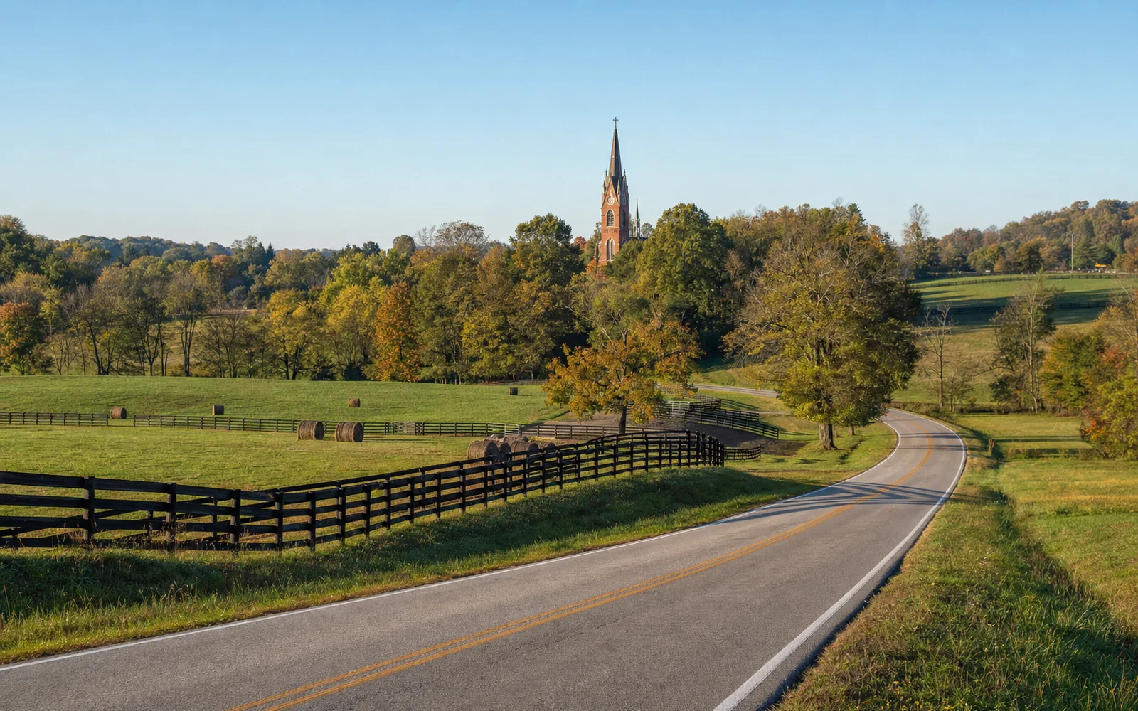 Country road winding through rolling autumn farmland toward a distant brick church tower among trees, AI-generated illustration