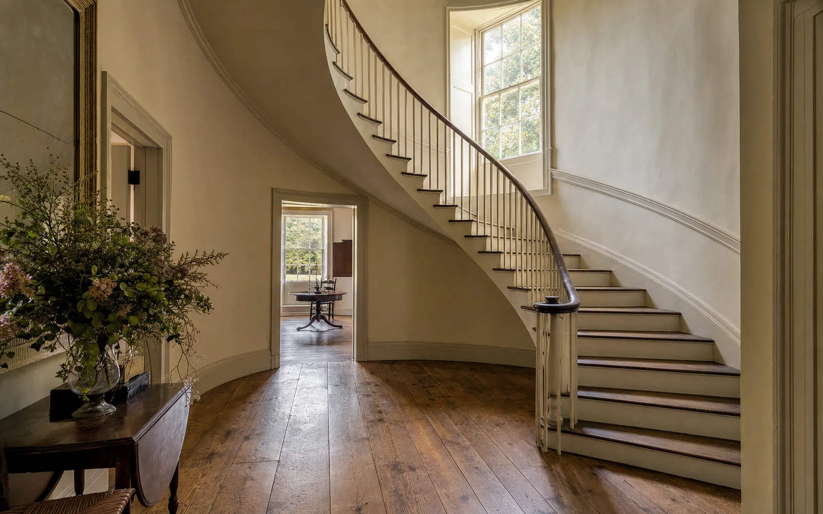 Graceful cantilevered wooden staircase curving up through a tall Georgian entrance hall with no visible support, AI-generated illustration
