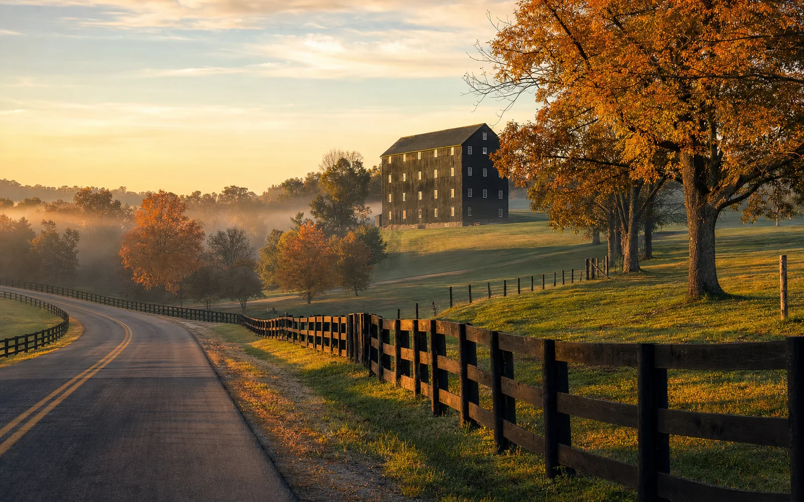 A two-lane country road curving past a dark-sided bourbon warehouse on a hill above autumn farmland at sunrise, AI-generated illustration