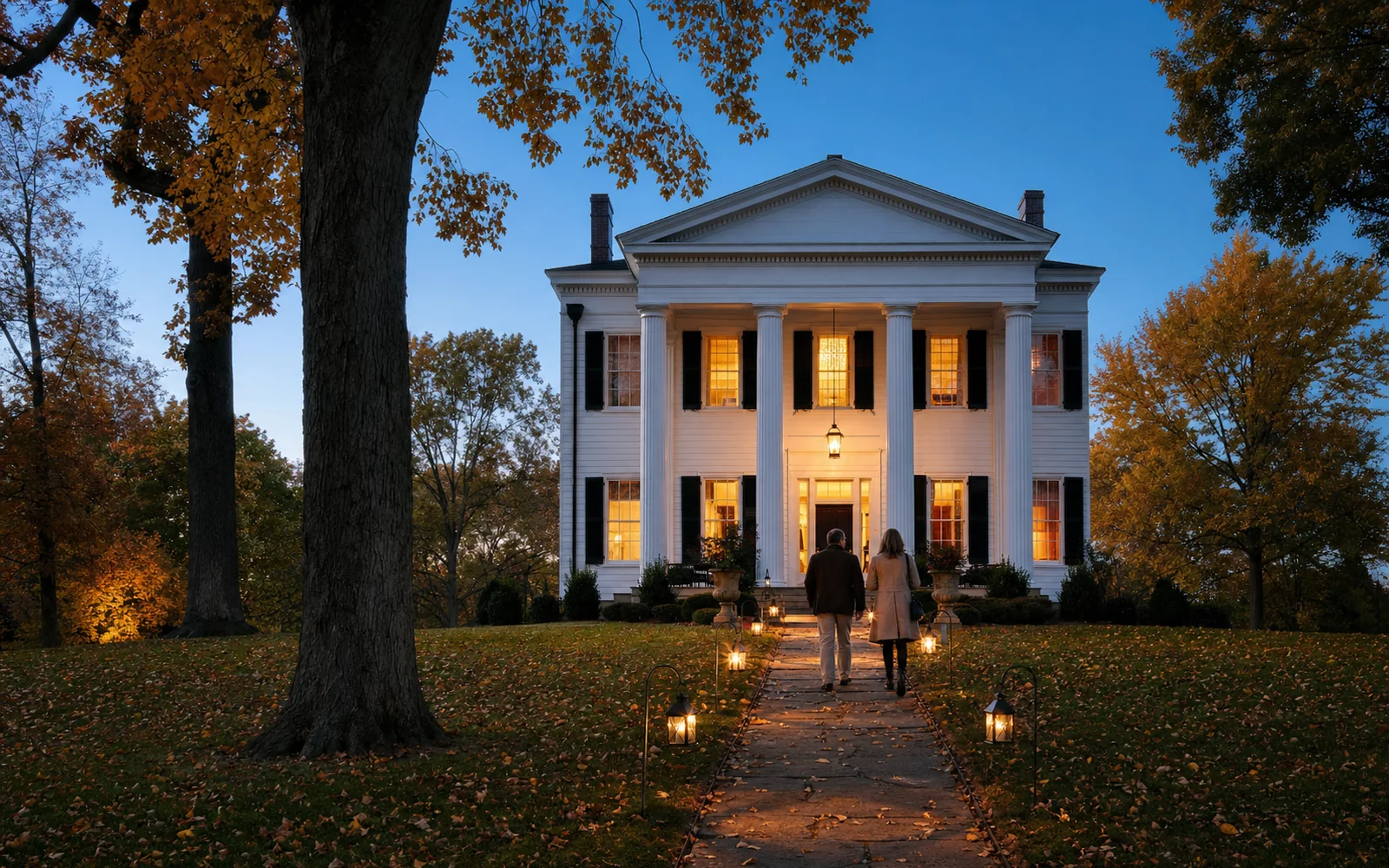 A Greek Revival antebellum house among tall trees at dusk in autumn, its windows lit and fallen leaves on the lawn, AI-generated illustration