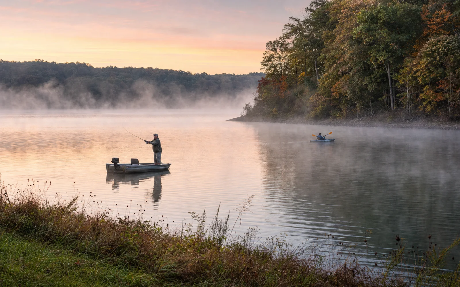 Angler casting from a small fishing boat at dawn on a misty lake ringed by wooded hills, with a kayaker in the distance, AI-generated illustration